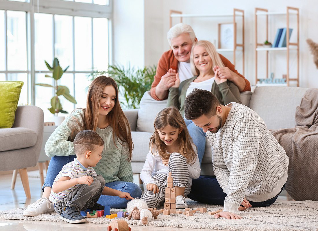 Personal Insurance - Happy Family Playing a Game Together at Home